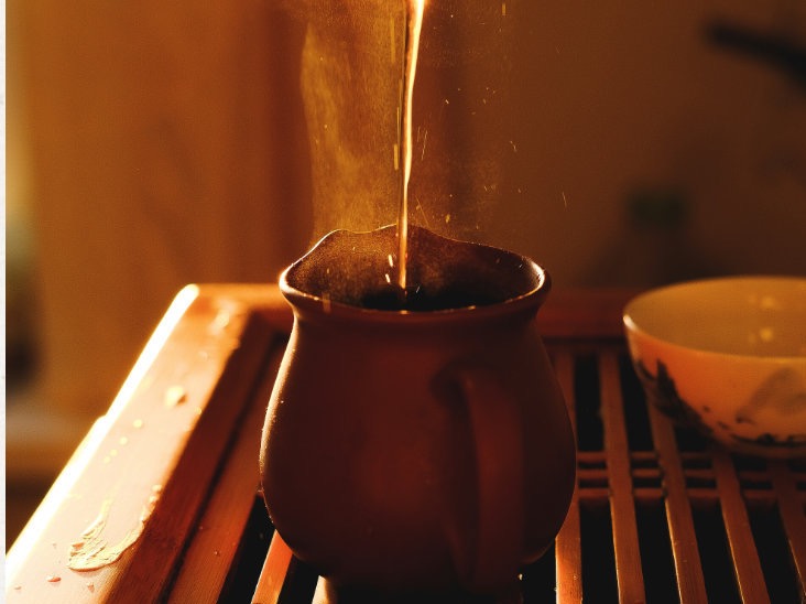 Tea being poured into a cup during brewing